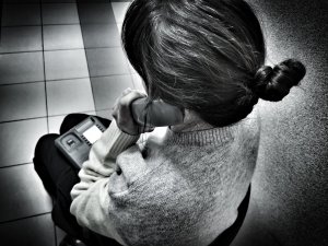 starsza kobieta trzyma słuchawkę przy uchu